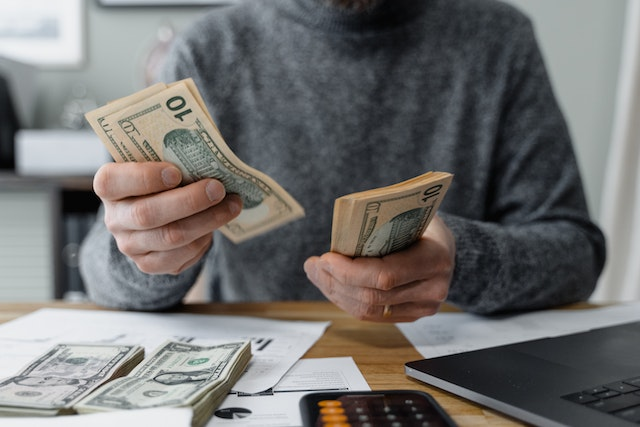 A healthcare provider counting dollar bills