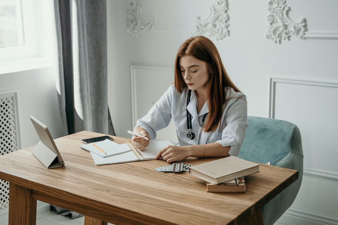 a doctor filling out paperwork. 